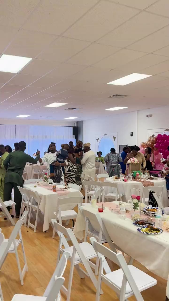 Video from the DJ table at a celebration in a bright hall in Richmond, Virginia: guests in traditional dress dancing between the tables.